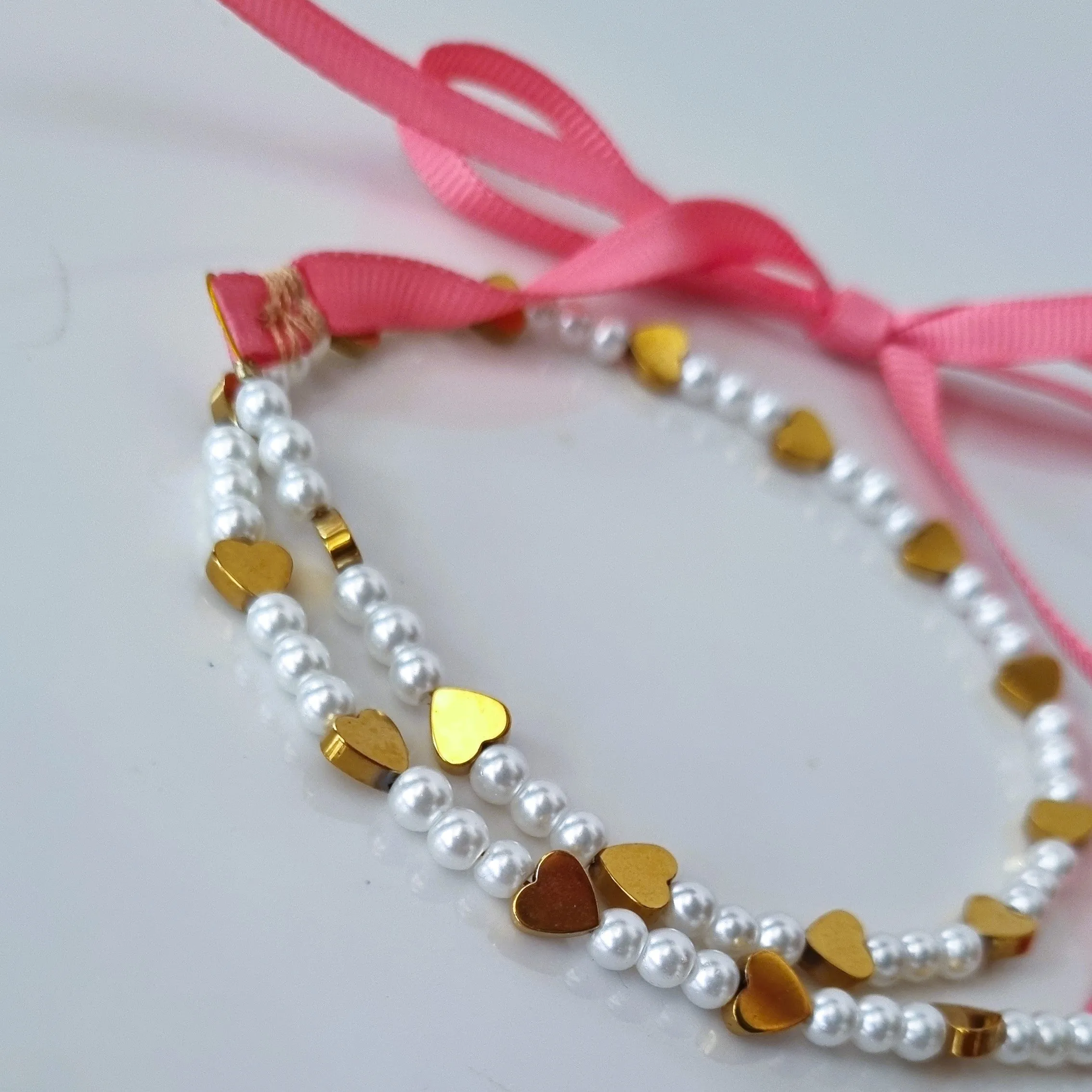 Gold hearts on ribbon